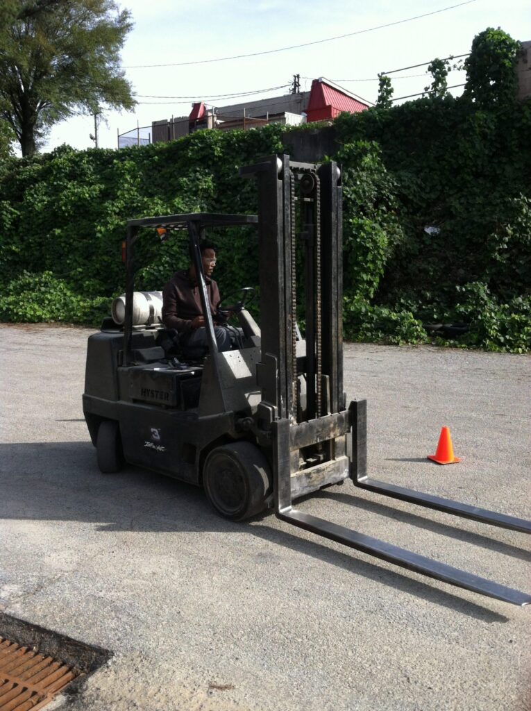 A man driving a forklift